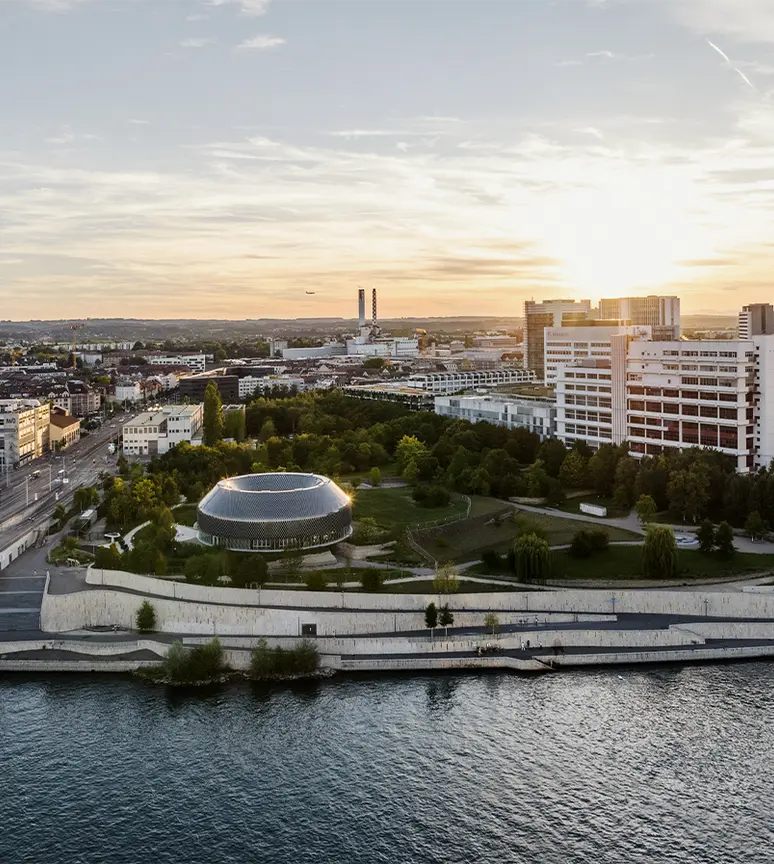 basel-city-with-river-and-the-novartis-campus-at-sunset-header