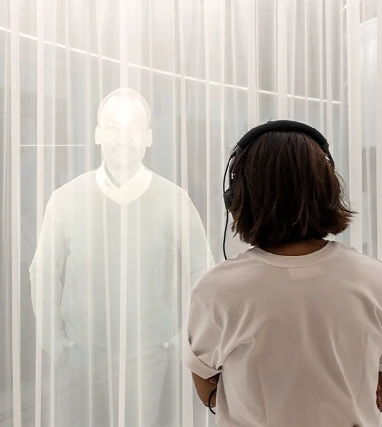 person-observing-figures-in-a-luminous-installation-at-novartis-pavillon