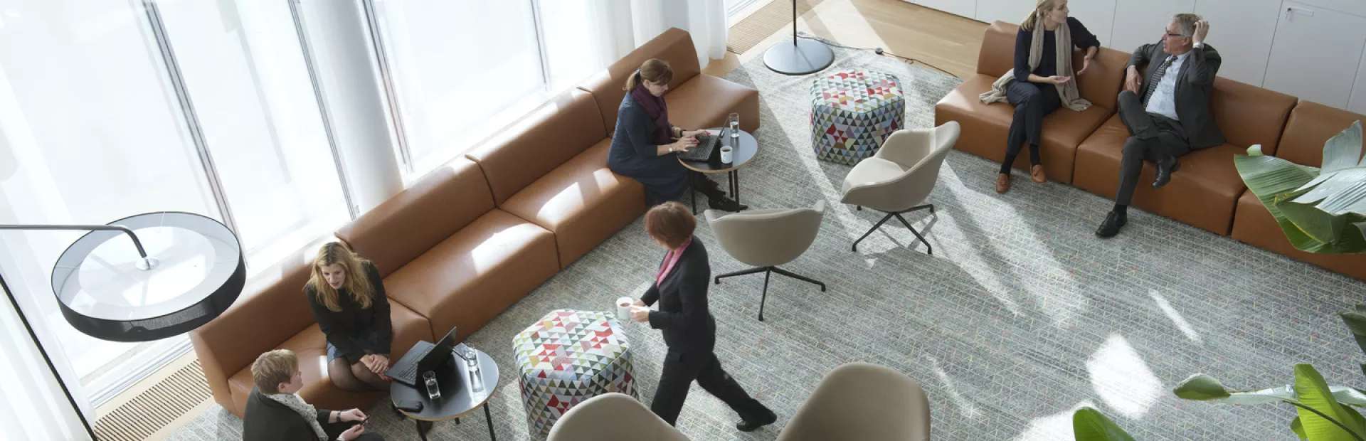 Groups of people in discussion in a lounge on Novartis Campus