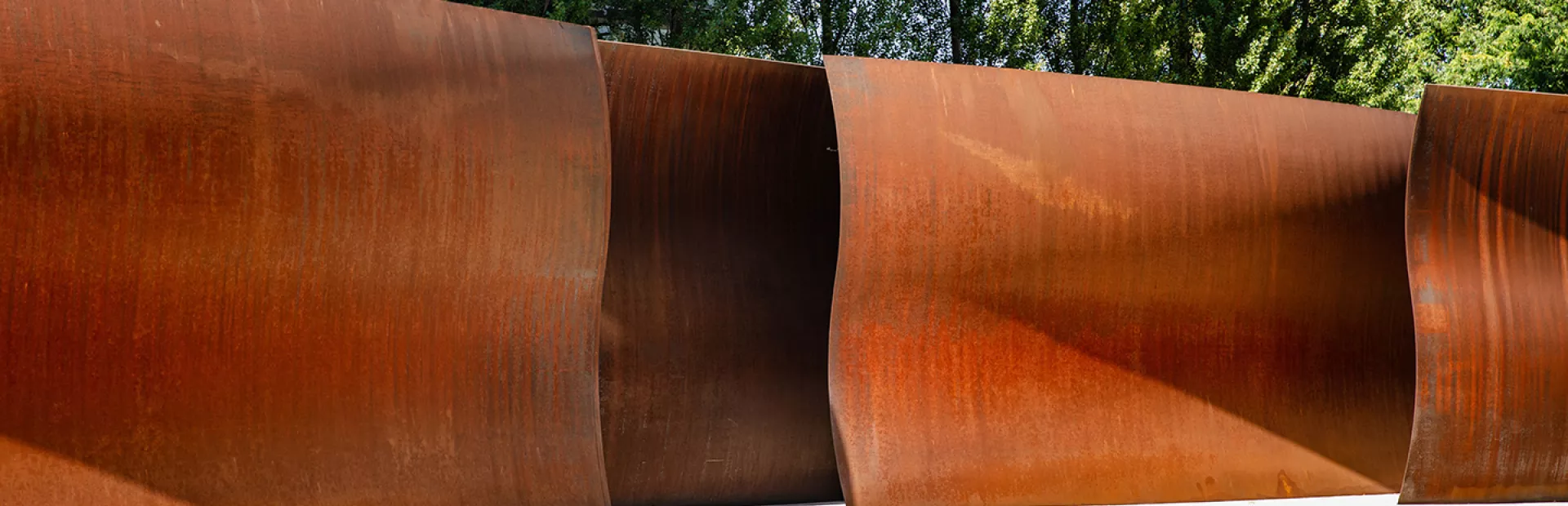 Dirk's Pod by Richard Serra, a large-scale sculpture on campus consisting of tall, waved walls