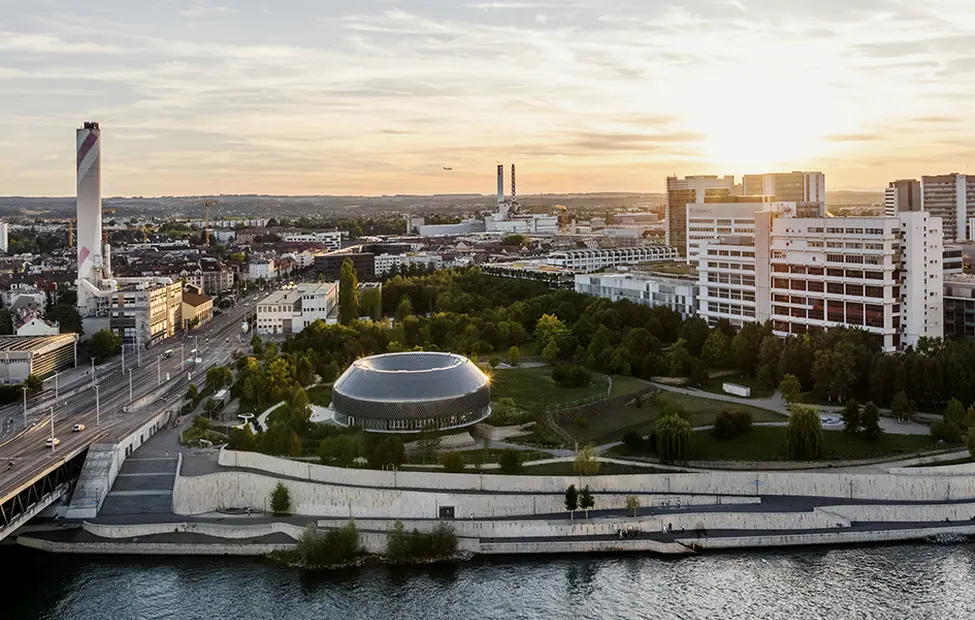basel-city-with-river-and-the-Novartis-campus-at-sunset.png