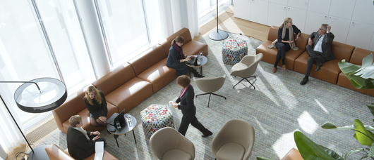 Groups of people in discussion in a lounge on Novartis Campus