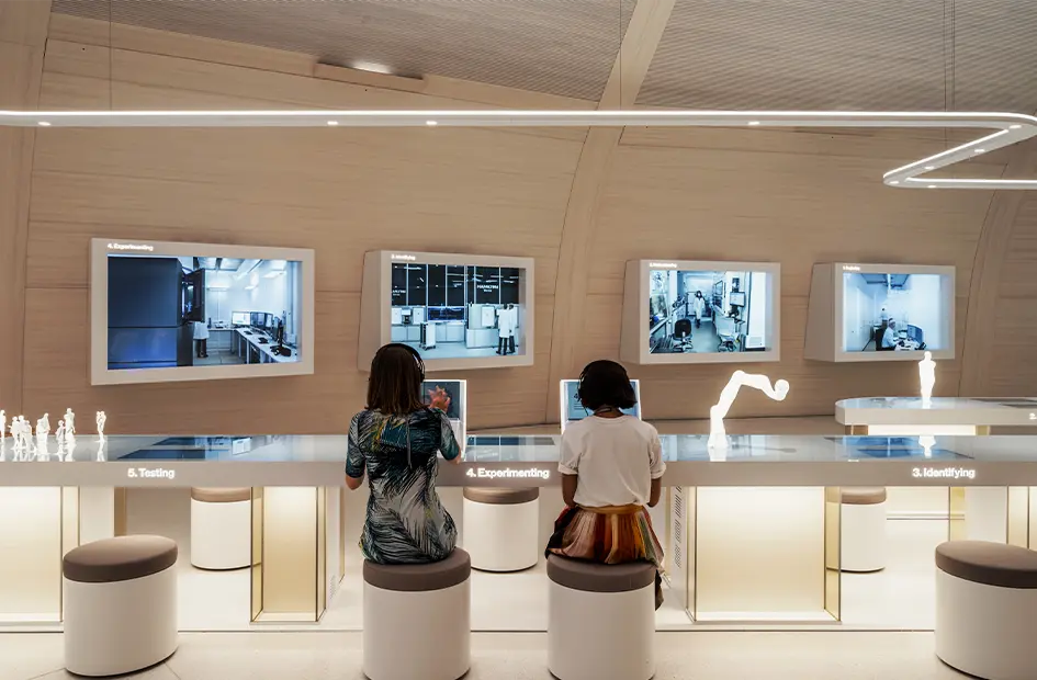 people-observing-interactive-exhibits-in-the-novartis-pavillon